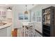 Bright dining area with white table, chairs, and stylish decor, next to kitchen at 467 Nelliefield Trl, Wando, SC 29492