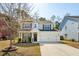 Traditional home featuring manicured landscaping, light gray exterior, black shutters and attached two car garage at 467 Nelliefield Trl, Wando, SC 29492
