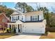 Charming two-story home featuring a well-maintained lawn, attached garage and a classic color palette at 467 Nelliefield Trl, Wando, SC 29492