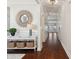 Inviting hallway with dark hardwood floors, stylish console table, decorative mirror and recessed lighting at 467 Nelliefield Trl, Wando, SC 29492