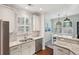 Bright kitchen featuring granite countertops, stainless steel appliances, and white cabinetry at 467 Nelliefield Trl, Wando, SC 29492