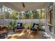 Relaxing screened-in patio with cozy seating and lush green views, ideal for outdoor lounging and entertaining at 467 Nelliefield Trl, Wando, SC 29492