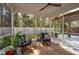 Inviting screened-in patio with comfortable seating and serene backyard views, perfect for relaxing and enjoying nature at 467 Nelliefield Trl, Wando, SC 29492