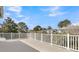 Balcony with white railings offers a view of trees, sky, and neighborhood houses at 4922 Sound View Dr, Mount Pleasant, SC 29466