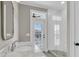 Bathroom showcasing marble countertops, glass shower, and stylish fixtures with a door to a private outdoor space at 4922 Sound View Dr, Mount Pleasant, SC 29466
