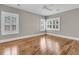 A charming bedroom showcasing hardwood floors, neutral paint, and plantation shutters for ample natural light at 4922 Sound View Dr, Mount Pleasant, SC 29466