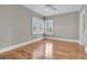 Bedroom featuring hardwood floors, neutral paint, plantation shutters, and a ceiling fan for added comfort at 4922 Sound View Dr, Mount Pleasant, SC 29466