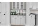 Stylish butler's pantry with white cabinets, mirrored backsplash, and convenient access to the laundry area at 4922 Sound View Dr, Mount Pleasant, SC 29466