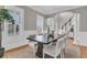 Elegant dining room featuring a large wooden table, jute rug, and natural light from shuttered windows at 4922 Sound View Dr, Mount Pleasant, SC 29466
