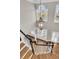 Staircase with wood steps, black railing, white risers, and stylish pendant lighting at 4922 Sound View Dr, Mount Pleasant, SC 29466
