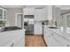 Bright kitchen featuring white cabinetry, stainless steel appliances, and quartz countertops at 4922 Sound View Dr, Mount Pleasant, SC 29466