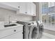 Convenient laundry room with modern washer and dryer, ample storage, and natural light at 4922 Sound View Dr, Mount Pleasant, SC 29466