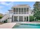 Back of house with inviting private pool and screened porch for outdoor living at 4922 Sound View Dr, Mount Pleasant, SC 29466