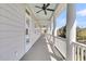 A long porch with a blue ceiling, large columns, and white railings under a clear blue sky at 4922 Sound View Dr, Mount Pleasant, SC 29466