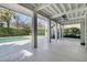 Spacious covered porch with ceiling fans and view of pool and manicured backyard at 4922 Sound View Dr, Mount Pleasant, SC 29466