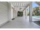 Covered porch with white columns and ceiling fans, offering a relaxing outdoor space by the pool at 4922 Sound View Dr, Mount Pleasant, SC 29466
