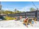 Inviting back patio with cozy seating, decorative string lights, and a stylish concrete fire pit, perfect for outdoor entertaining at 523 Coaxum Rd, Mount Pleasant, SC 29464