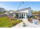 Spacious backyard featuring a screened porch, lush landscaping, a grill, and a stylish patio area with comfortable seating at 523 Coaxum Rd, Mount Pleasant, SC 29464