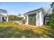 Cozy backyard storage shed with double doors and a window, providing a functional and stylish addition to the property at 523 Coaxum Rd, Mount Pleasant, SC 29464
