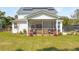 Expansive backyard with a screened porch, lush landscaping, and comfortable seating, perfect for relaxing and outdoor entertaining at 523 Coaxum Rd, Mount Pleasant, SC 29464