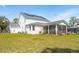 Spacious backyard featuring solar panels, screened-in porch with furniture at 523 Coaxum Rd, Mount Pleasant, SC 29464