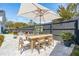 Large backyard patio area featuring an umbrella-covered table, a garden potting station, and comfortable seating for outdoor enjoyment at 523 Coaxum Rd, Mount Pleasant, SC 29464
