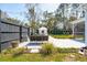 Inviting backyard featuring a stone patio, lounge seating, and landscaped garden with lighting at 523 Coaxum Rd, Mount Pleasant, SC 29464