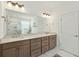 Bathroom features a double vanity with granite countertops, stylish fixtures, and a large mirror, creating a luxurious feel at 523 Coaxum Rd, Mount Pleasant, SC 29464