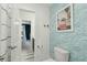 Stylish bathroom featuring patterned wallpaper, a modern toilet, and an open doorway to other parts of the home at 523 Coaxum Rd, Mount Pleasant, SC 29464