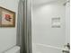 Bathroom with a white subway tile shower, gray shower curtain, and a framed floral print above the toilet at 523 Coaxum Rd, Mount Pleasant, SC 29464