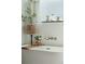 Close-up view of a freestanding tub featuring stylish accents, plants, and natural light from the window at 523 Coaxum Rd, Mount Pleasant, SC 29464