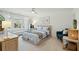 Bedroom with a large window, a sitting area, and a comfortable bed adorned with patterned linens at 523 Coaxum Rd, Mount Pleasant, SC 29464