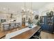 Bright dining area featuring a modern chandelier, open to the kitchen, and hardwood floors at 523 Coaxum Rd, Mount Pleasant, SC 29464