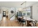 Bright dining area with a large window, modern light fixture, and hardwood floors at 523 Coaxum Rd, Mount Pleasant, SC 29464