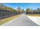 Gravel driveway, black fence lined with greenery in a residential area at 523 Coaxum Rd, Mount Pleasant, SC 29464