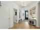 Bright entryway with hardwood floors, white walls, and modern light fixture above at 523 Coaxum Rd, Mount Pleasant, SC 29464