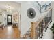 Bright entryway features modern staircase, stylish light fixture, and decor, creating a welcoming and elegant ambiance at 523 Coaxum Rd, Mount Pleasant, SC 29464