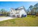 Well-maintained exterior with three-car garage, stone accents, and landscaping at 523 Coaxum Rd, Mount Pleasant, SC 29464