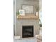 Close up of a modern fireplace with wood mantel, and neutral paint at 523 Coaxum Rd, Mount Pleasant, SC 29464
