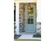 Inviting entryway featuring a stylish teal door, stone accents, and a lantern, complete with visible house numbers at 523 Coaxum Rd, Mount Pleasant, SC 29464