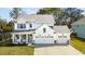 Beautiful two-story modern farmhouse with a three-car garage, stone accents, and inviting front porch at 523 Coaxum Rd, Mount Pleasant, SC 29464