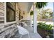 Cozy front porch with rocking chairs, stone accents, and hanging plants, offering a relaxing outdoor space at 523 Coaxum Rd, Mount Pleasant, SC 29464