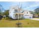 Beautiful home with a well-maintained lawn and landscaping, accentuated by a young tree in the front yard at 523 Coaxum Rd, Mount Pleasant, SC 29464