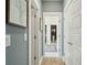 Hallway view into a bathroom and walk-in closet; neutral colors and modern finishes at 523 Coaxum Rd, Mount Pleasant, SC 29464