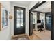 Stylish home office featuring dark accent walls, custom built-ins, ample natural light, and modern furnishings at 523 Coaxum Rd, Mount Pleasant, SC 29464