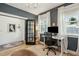 Modern office space with light-filled windows, custom built-ins, and warm hardwood flooring, designed for efficiency at 523 Coaxum Rd, Mount Pleasant, SC 29464