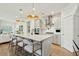 Modern kitchen with a large island, pendant lighting, and stainless steel appliances at 523 Coaxum Rd, Mount Pleasant, SC 29464