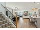 Open living space with hardwood floors, modern lighting, and a staircase at 523 Coaxum Rd, Mount Pleasant, SC 29464
