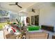 Inviting screened porch with plush seating, ceiling fans, and a view of the serene surroundings at 523 Coaxum Rd, Mount Pleasant, SC 29464