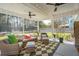 Large screened-in porch featuring comfortable wicker seating, fans, and backyard views at 523 Coaxum Rd, Mount Pleasant, SC 29464